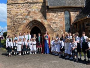 The gala court standing in front of Aberlady Kirk on Kirkin Sunday, a traditional part of Aberlady Gala week